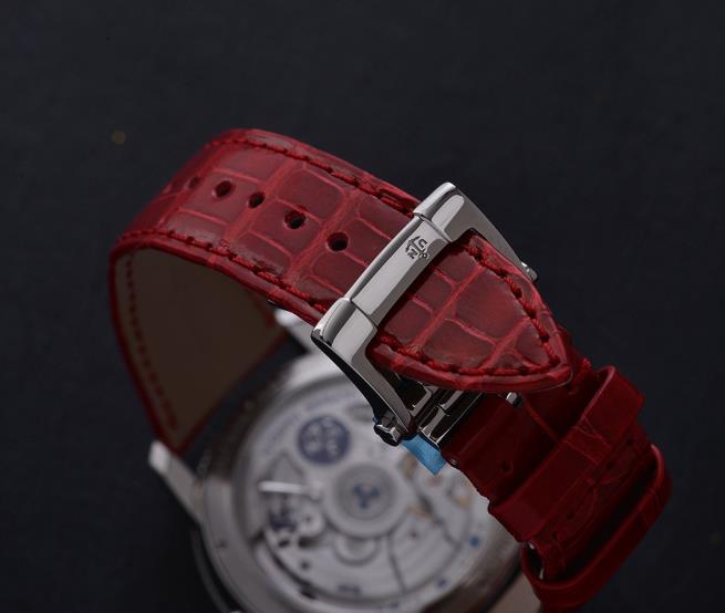 The 42mm replica watch has a red strap.